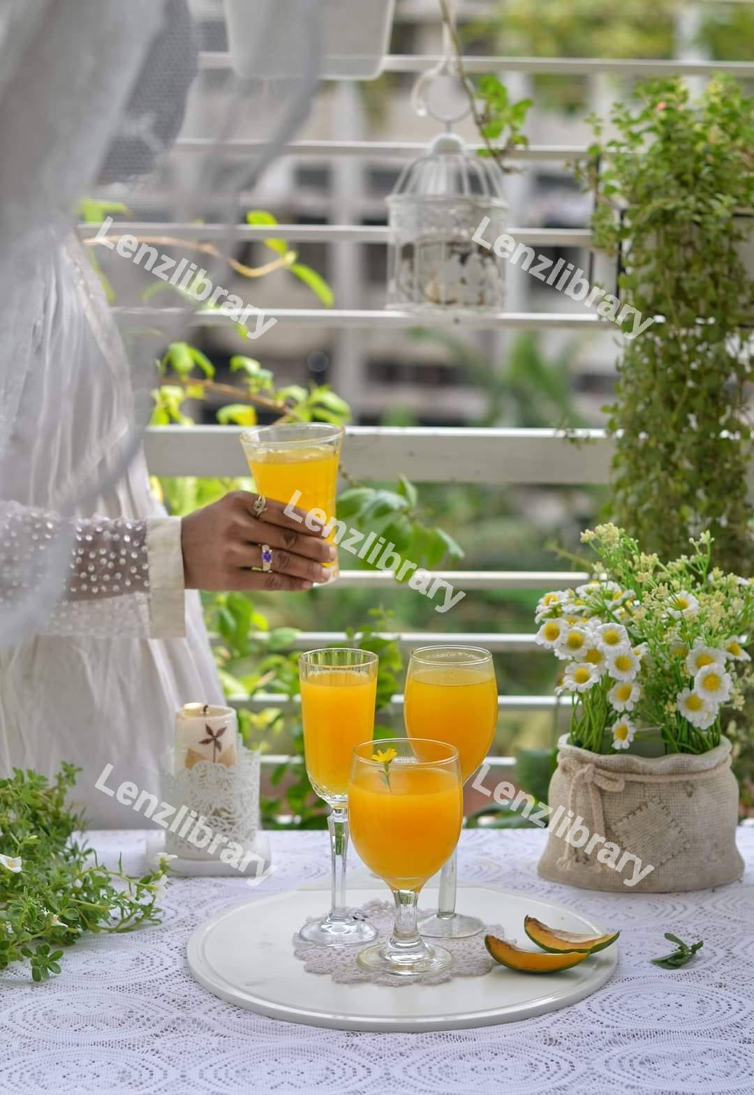 A woman holding a glass of melon juice
